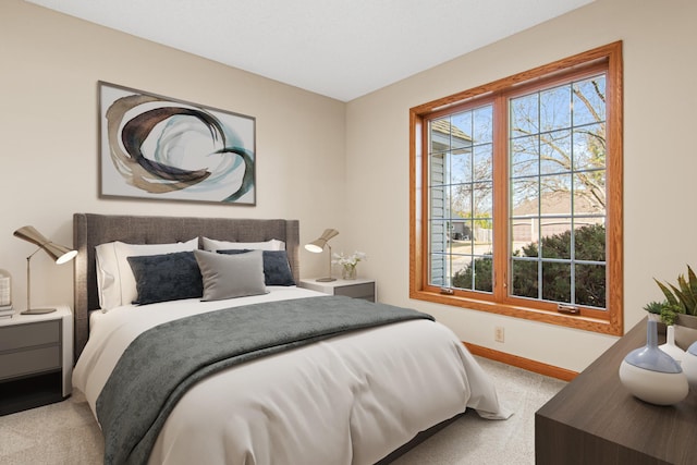bedroom featuring light carpet and baseboards