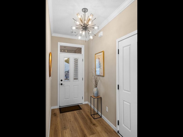 doorway featuring a notable chandelier, wood-type flooring, and ornamental molding