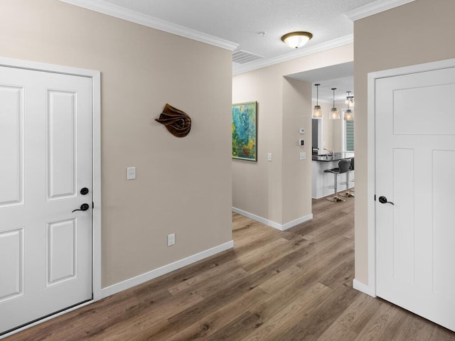 hallway featuring hardwood / wood-style flooring and ornamental molding