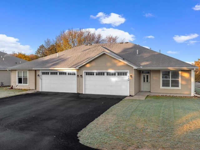 ranch-style home with a front yard and a garage