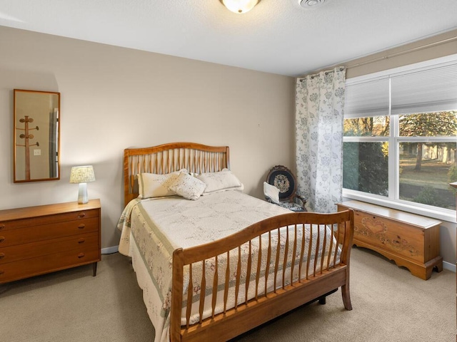 bedroom featuring light carpet