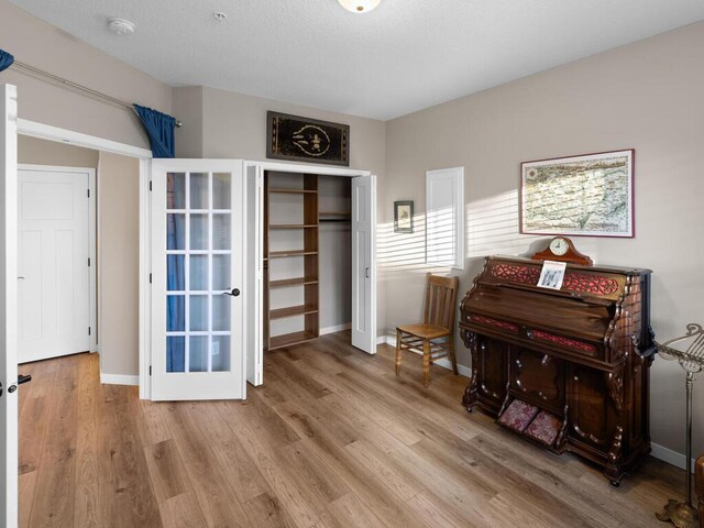 misc room featuring light wood-type flooring and french doors