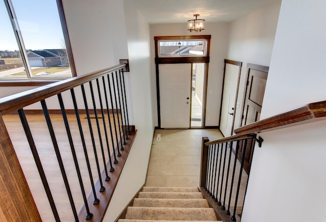 entryway featuring a wealth of natural light and a chandelier