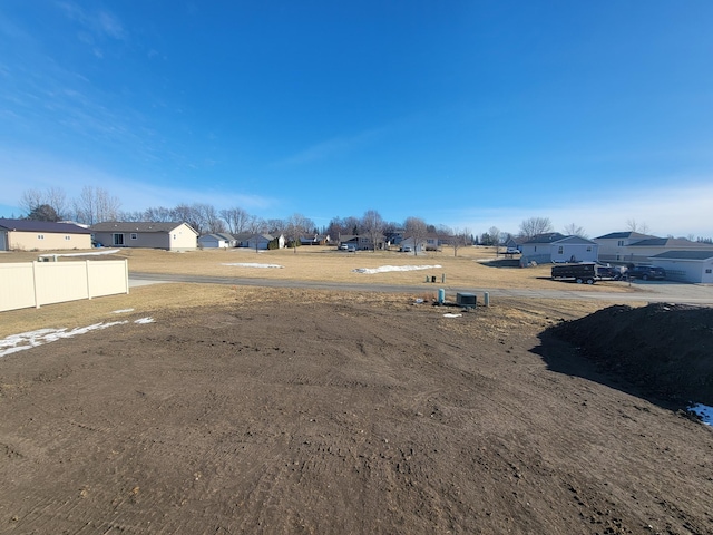 view of yard featuring fence and a residential view