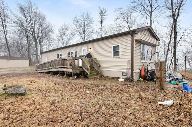 rear view of property with a wooden deck