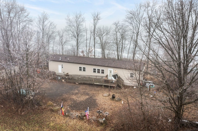 back of property with a wooden deck