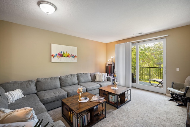 carpeted living room with a textured ceiling