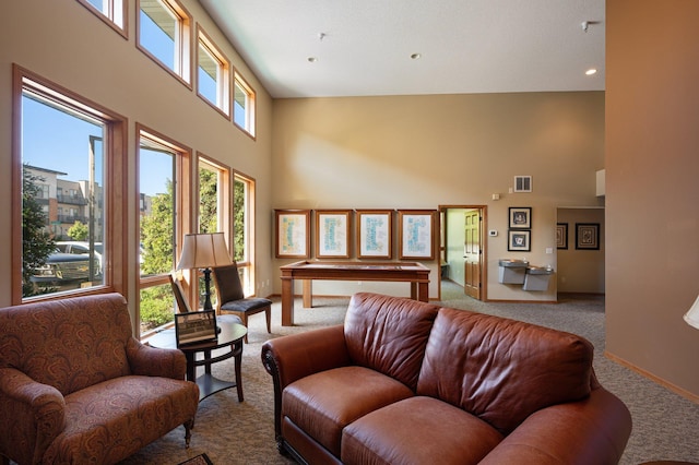 carpeted living room with a high ceiling