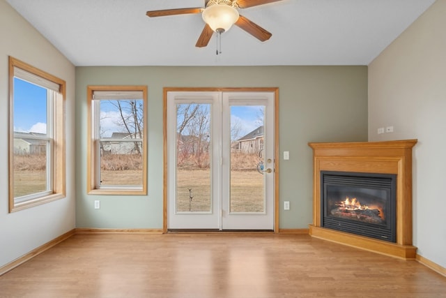 unfurnished living room featuring light hardwood / wood-style flooring and ceiling fan