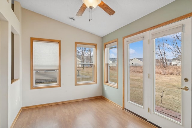 unfurnished sunroom with ceiling fan and lofted ceiling