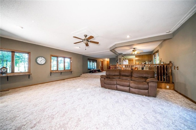 living room featuring ceiling fan, plenty of natural light, and light colored carpet