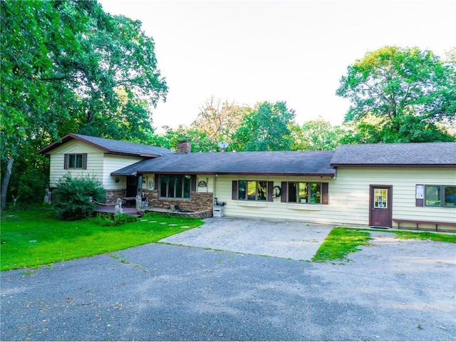 42150 County Road 1, Rice, MN 56367 - tri-level home featuring a chimney, driveway, and a front yard