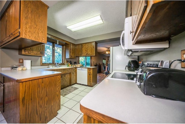 42150 County Road 1, Rice, MN 56367 - kitchen featuring white dishwasher, brown cabinets, light countertops, a textured ceiling, and light tile patterned flooring