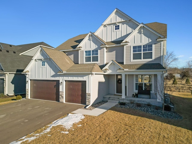 view of front of property featuring a garage and a front lawn