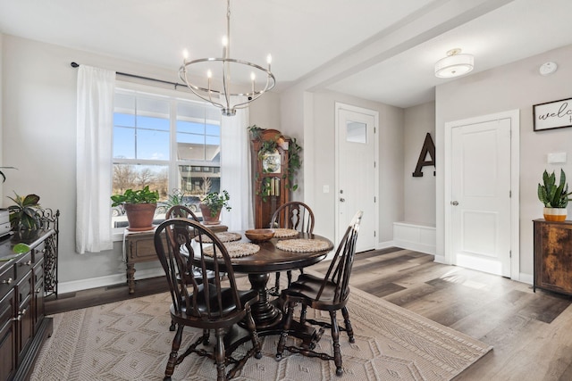 dining room featuring hardwood / wood-style flooring and a chandelier