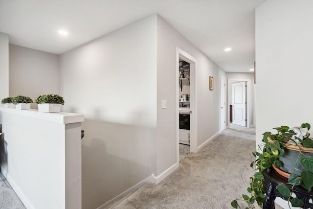 hall with light colored carpet