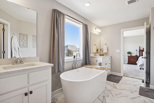 bathroom with vanity and a tub