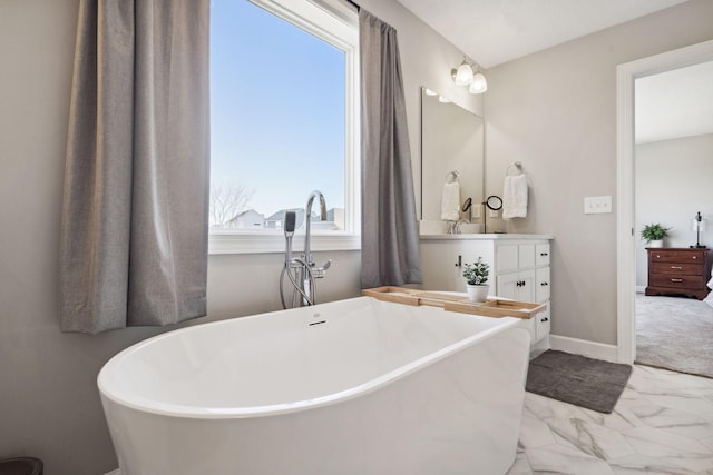 bathroom featuring a bath and vanity