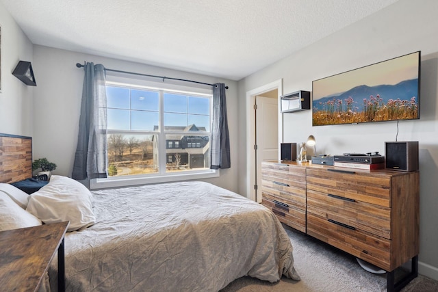 bedroom featuring carpet and a textured ceiling