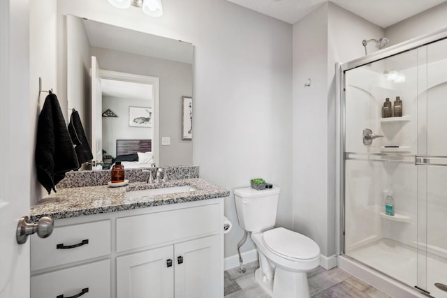 bathroom with vanity, toilet, and walk in shower