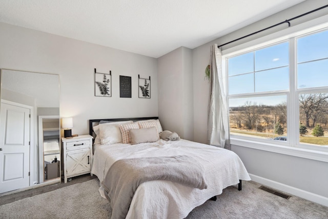 bedroom featuring light carpet and multiple windows