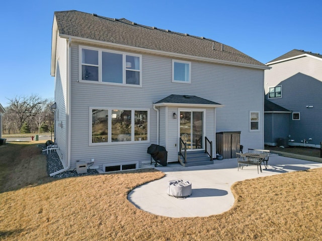 rear view of house with a lawn and a patio