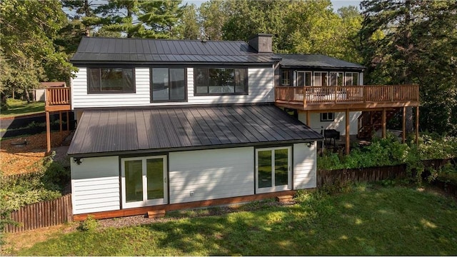 rear view of property with a yard and a deck