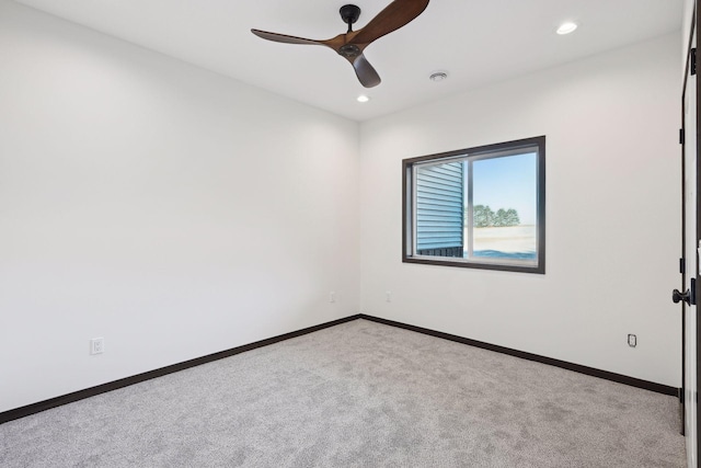 empty room featuring light colored carpet and ceiling fan