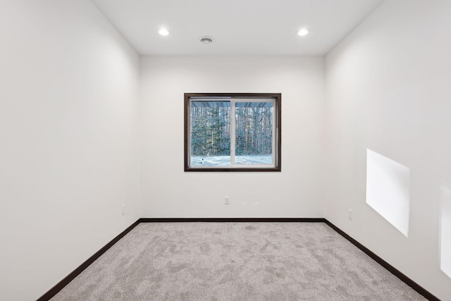 spare room with light colored carpet