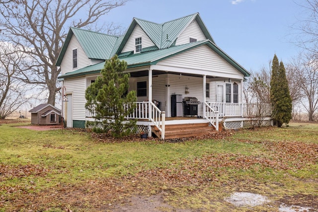 view of front of property with a porch and a front yard