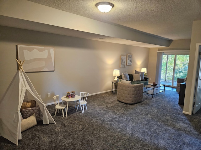 living room with dark colored carpet and a textured ceiling