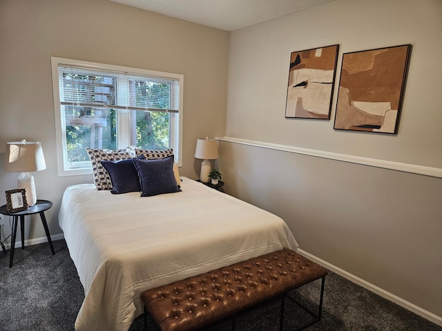 bedroom featuring dark colored carpet