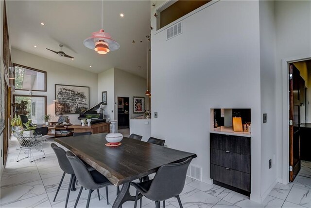 dining space featuring high vaulted ceiling and ceiling fan