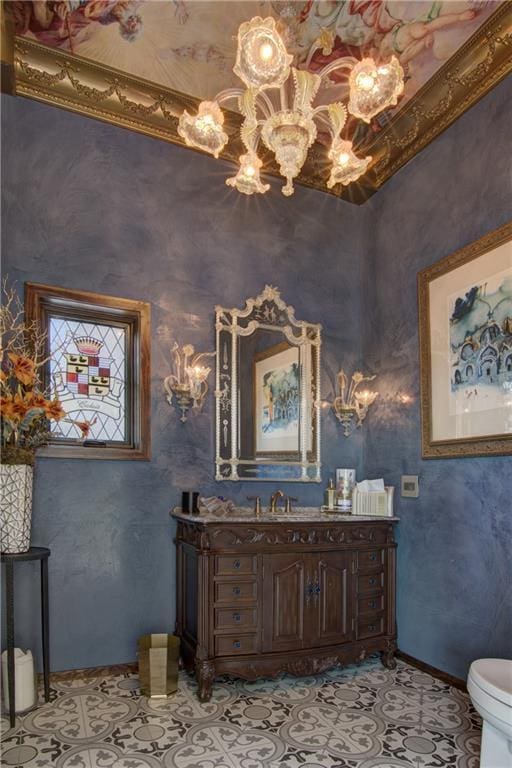 bathroom with vanity, toilet, and a high ceiling