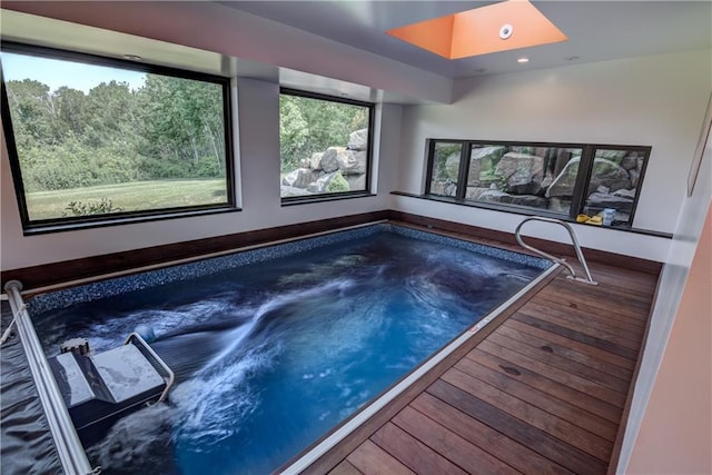 view of swimming pool with an indoor hot tub