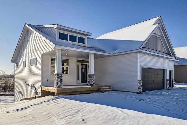 view of front of property featuring a garage and a porch