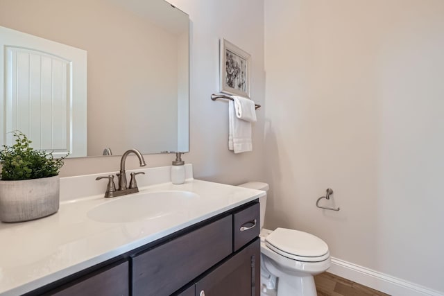 bathroom with vanity, wood-type flooring, and toilet