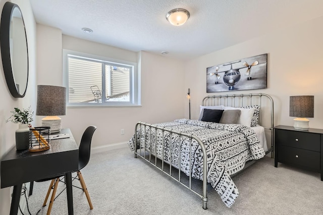 carpeted bedroom featuring a textured ceiling