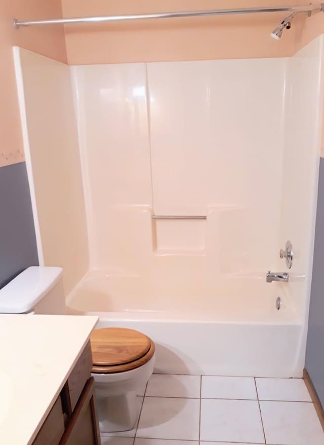 full bathroom with toilet, tile patterned floors, bathing tub / shower combination, and vanity