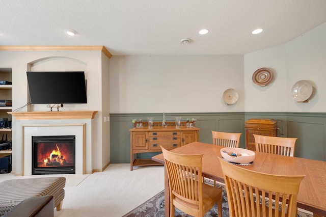 dining room with carpet and a textured ceiling