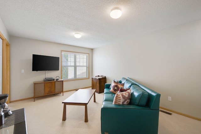 carpeted living room featuring a textured ceiling