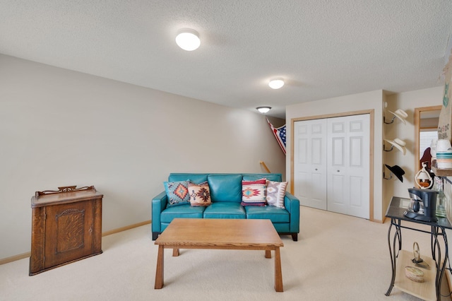 living room with light carpet and a textured ceiling