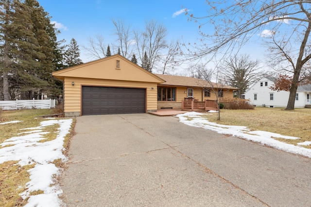 single story home with a lawn and a garage