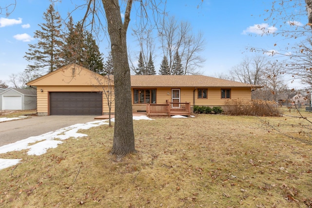 single story home featuring a front yard, a garage, and a wooden deck