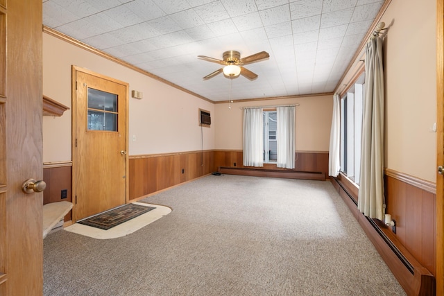 unfurnished room with carpet flooring, ceiling fan, and crown molding