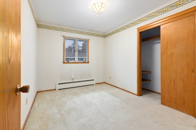 unfurnished bedroom with baseboard heating, light carpet, and a closet