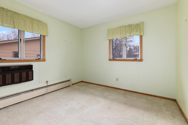 carpeted empty room with a baseboard radiator