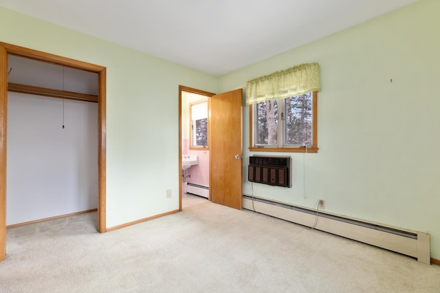 unfurnished bedroom featuring light carpet, a closet, a baseboard radiator, and a wall mounted AC