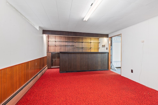 interior space featuring dark carpet and a baseboard heating unit