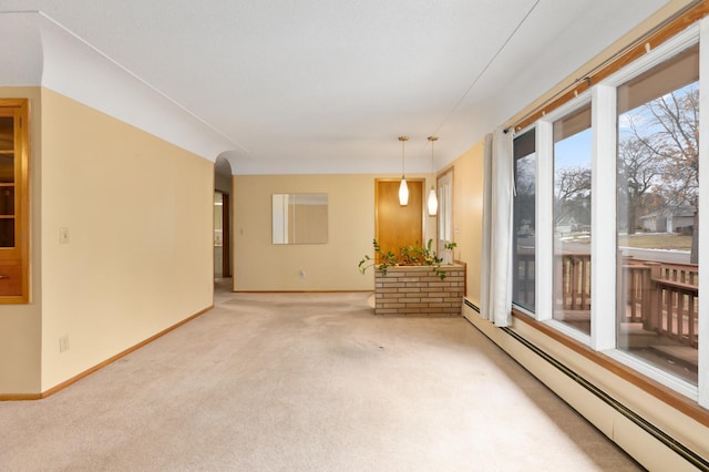 unfurnished room with carpet flooring and a baseboard heating unit